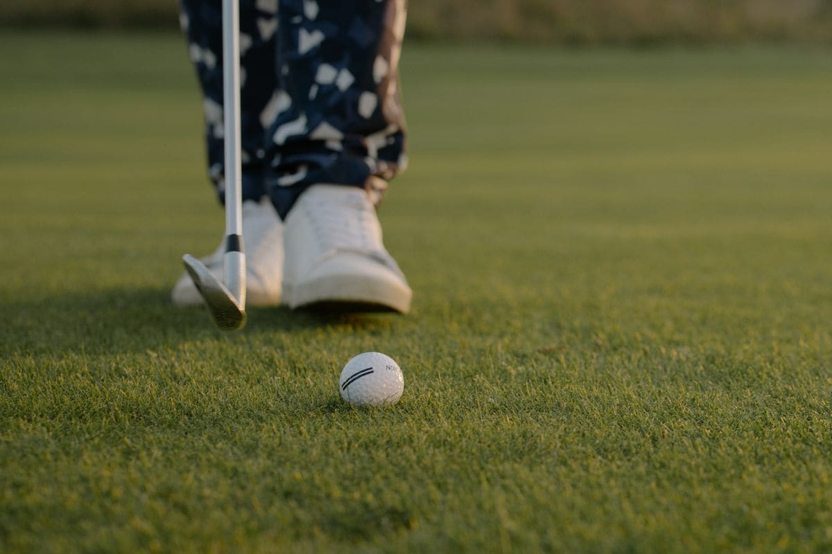 Close-up of a putt on a golden, sunlit green