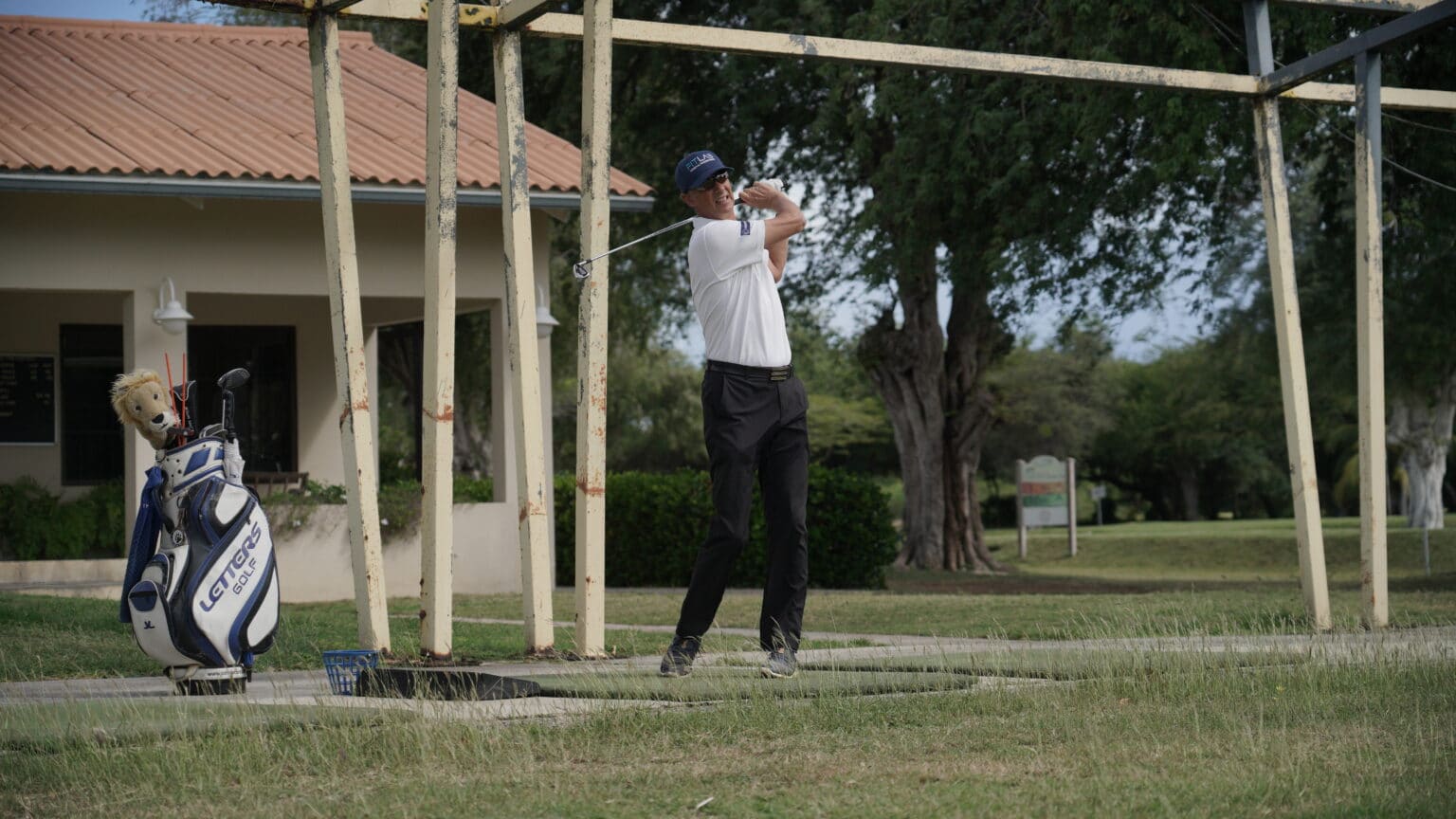Golf instructor Ed van Kampen in full swing at the driving range of the Curaçao Golf & Squash Club in Emmastad, Willemstad